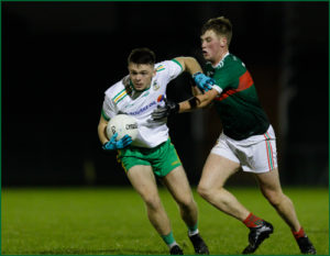 Karl McMenamin in action for Carrickmacross Emmets along with Inniskeen's Andrew Woods.